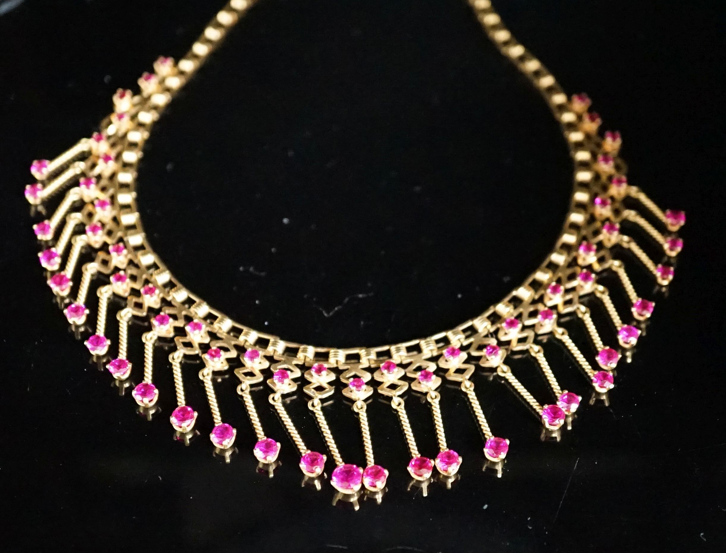 A modern yellow metal (stamped 18) and synthetic ruby? set drop fringe necklace, 41cm, gross 35 grams.